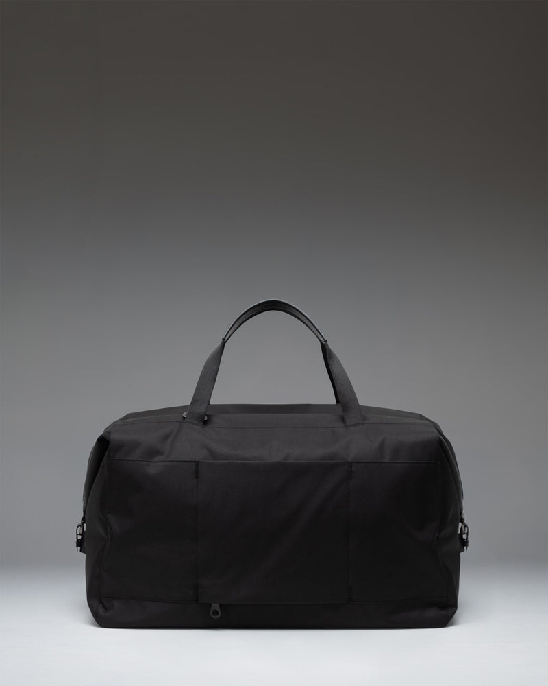 Herschel Supply Co. Maia Weekender duffel bag in black, featuring a spacious design and durable fabric ideal for travel and weekend getaways.