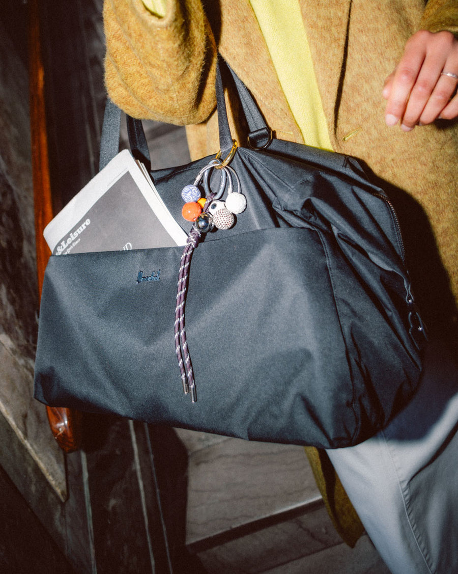 Herschel Supply Co. Maia Weekender bag in a multi-color grid pattern displayed against a clean background.