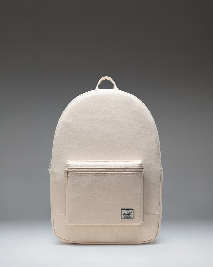 Herschel Supply Co. Pacific Daypack in Natural, showing a clean, minimalistic design with adjustable shoulder straps and a front zippered pocket.