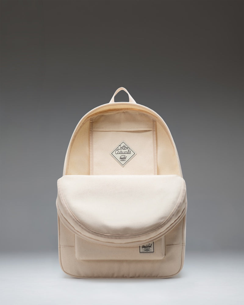 Herschel Supply Co. Pacific Daypack in Natural, a lightweight cotton canvas backpack featuring zippered closures and a front storage pocket.