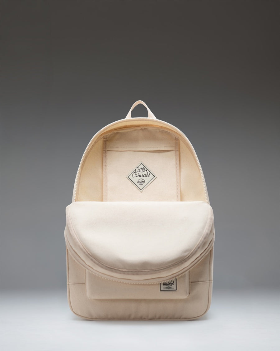 Herschel Supply Co. Pacific Daypack in Natural, a lightweight cotton canvas backpack featuring zippered closures and a front storage pocket.