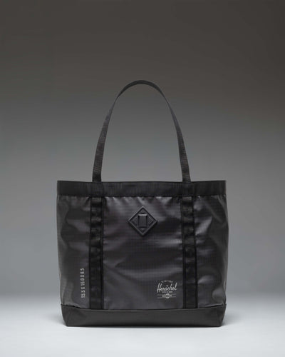 Herschel Supply Co. All Season Gear Tote 33 L in black, showing a lifestyle view of the durable everyday bag.