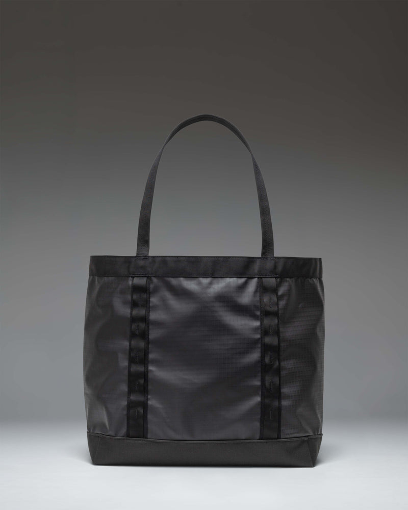 Herschel Supply Co. All Season Gear Tote 33L in black, featuring a spacious main compartment, sturdy nylon handles, and daisy chain webbing.