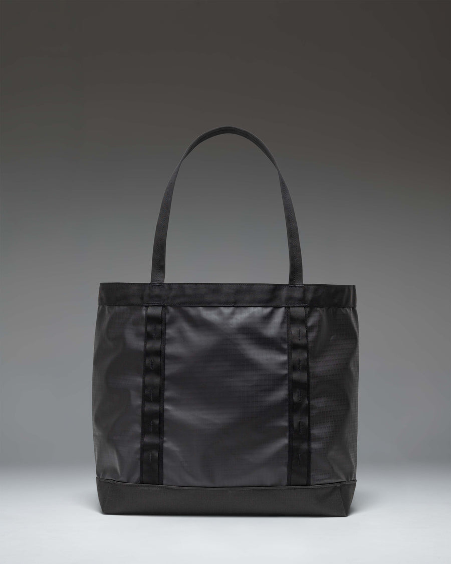 Herschel Supply Co. All Season Gear Tote 33L in black, featuring a spacious main compartment, sturdy nylon handles, and daisy chain webbing.