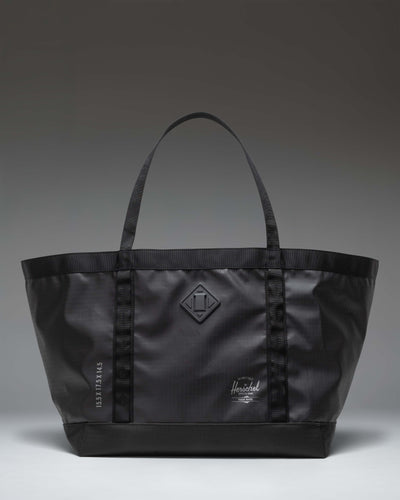 Herschel Supply Co. All Season Gear Tote 63L in black, shown from the front highlighting its large capacity and durable handles.
