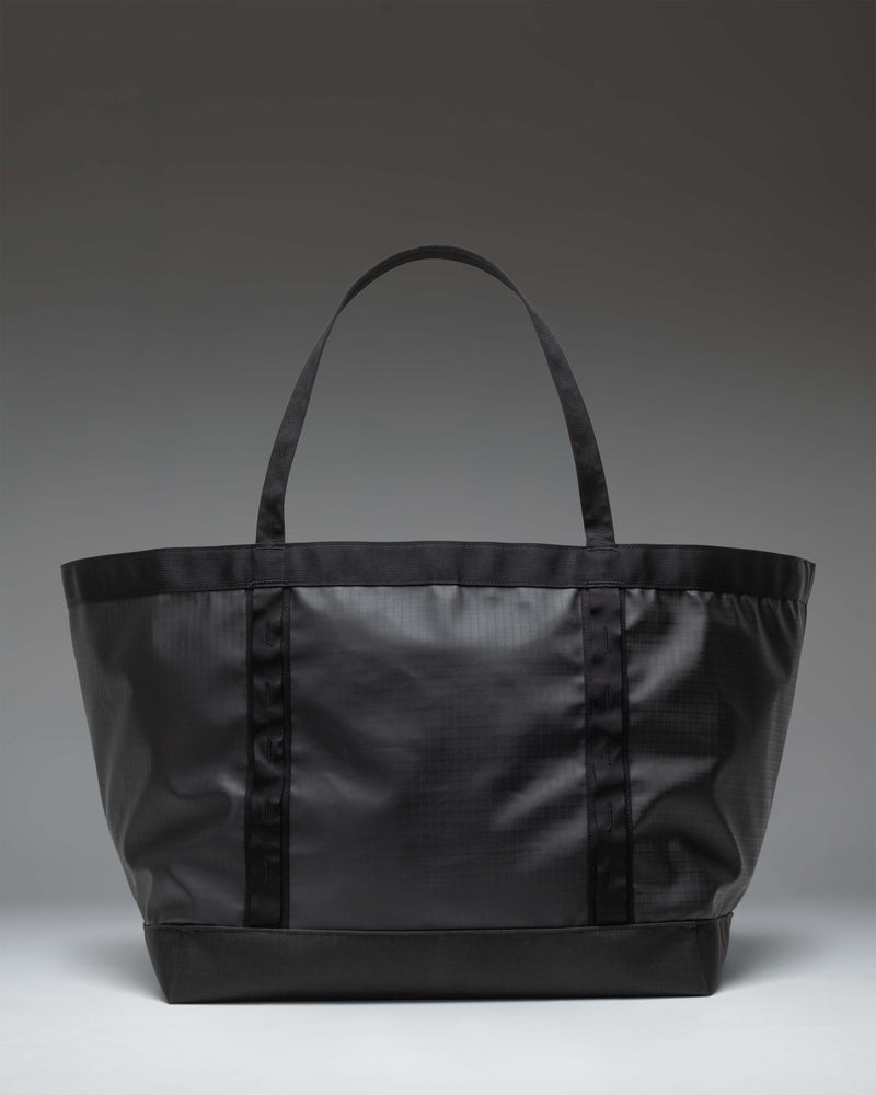Herschel Supply Co. All Season Gear Tote 63 L in Black, shown from the side to highlight its durable design and spacious capacity.