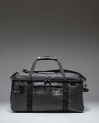 Herschel Supply Co. All Season Duffle bag 41 L in black, showing the clean front view with handles and adjustable shoulder strap.