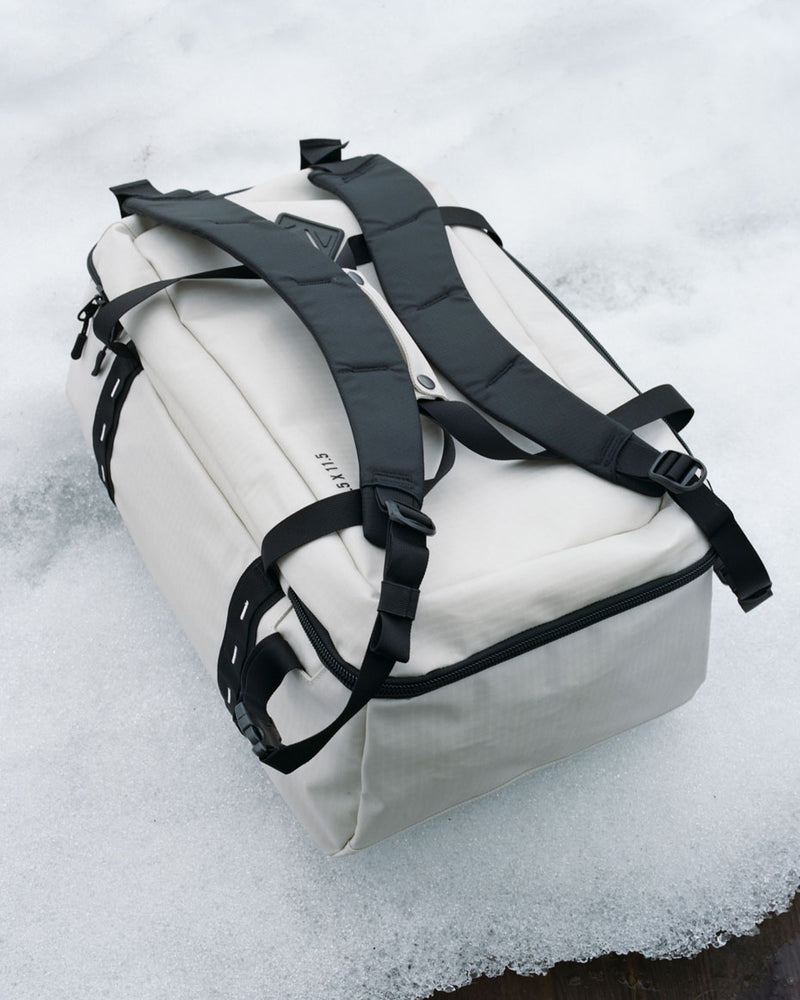 Herschel Supply Co. All Season Duffle 41L shown from multiple angles to display its weather-resistant fabric, straps, and spacious main compartment.