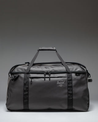 Herschel Supply Co All Season Duffle 66 L in Black, featuring a clean, classic duffle bag design with dual top handles.