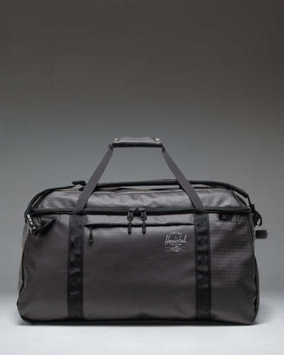 Herschel Supply Co All Season Duffle 66 L in Black, featuring a clean, classic duffle bag design with dual top handles.