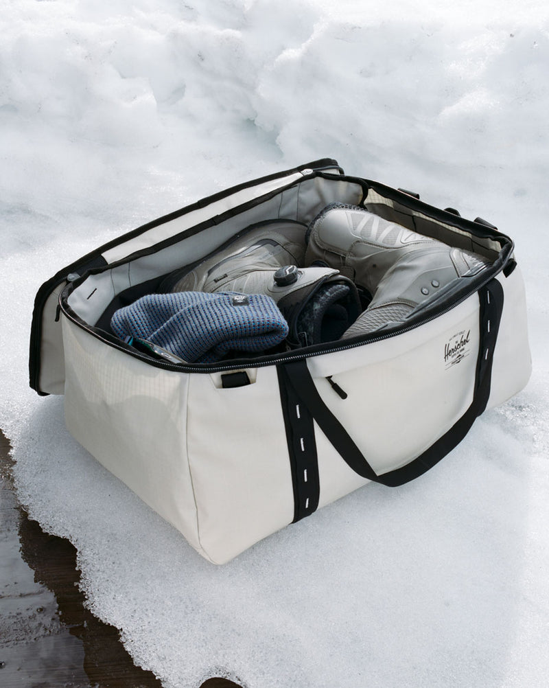 Herschel Supply Co. All Season Duffle 66L bags displayed in various colors to showcase the durable, water-repellent recycled fabric design.