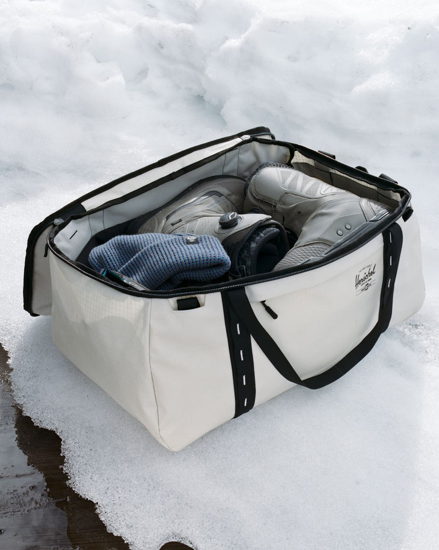 Herschel Supply Co. All Season Duffle 66L bags displayed in various colors to showcase the durable, water-repellent recycled fabric design.