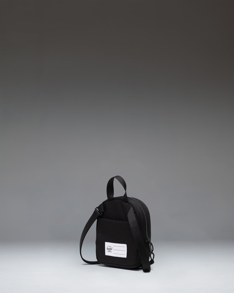 Black Herschel Heritage Crossbody Little Herschel bag shown from an lifestyle lifestyle perspective.
