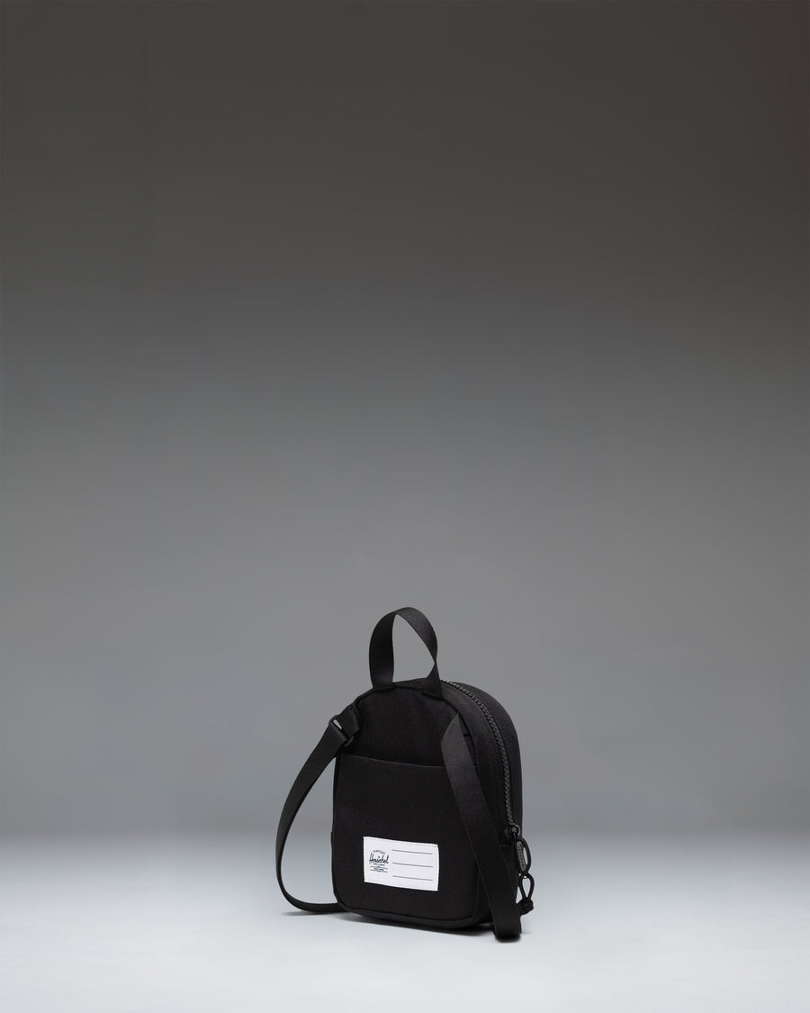 Black Herschel Heritage Crossbody Little Herschel bag shown from an lifestyle lifestyle perspective.