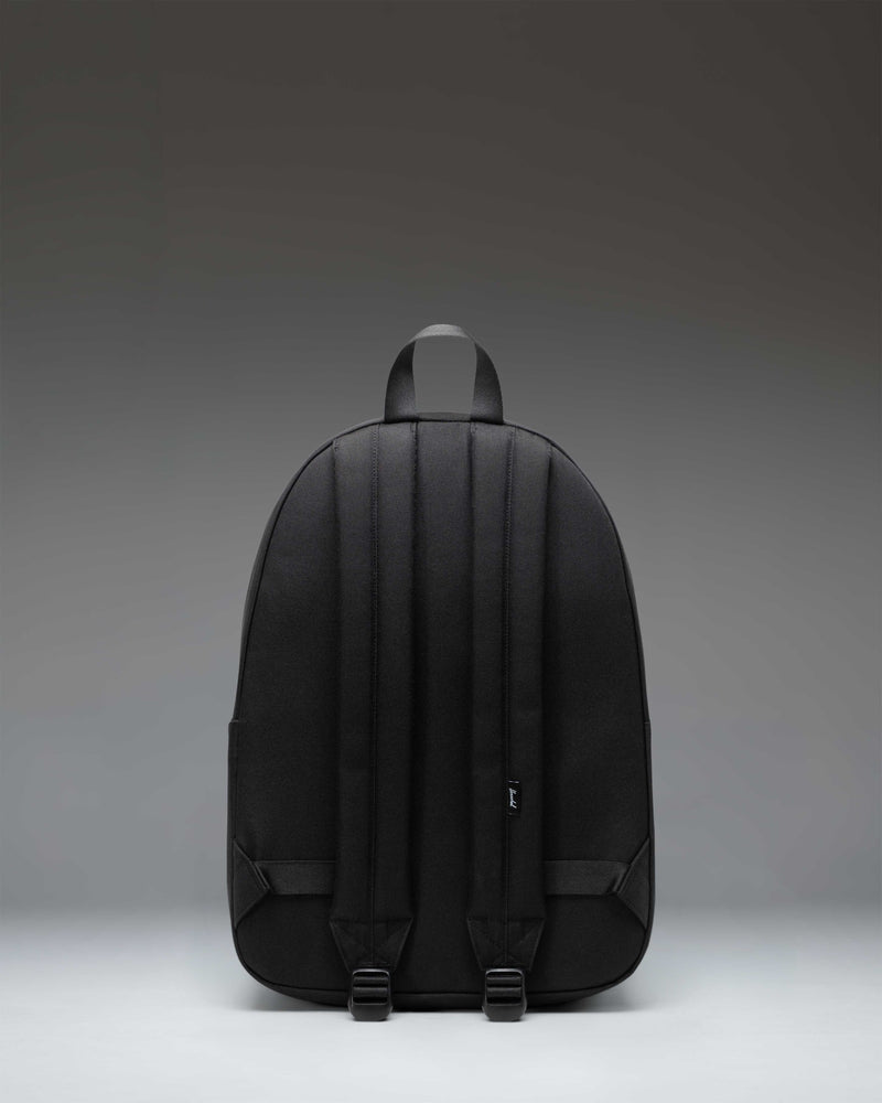 Herschel Supply Co. Classic Backpack in black, showing the front view with its main zipper pocket and a smaller front storage compartment.