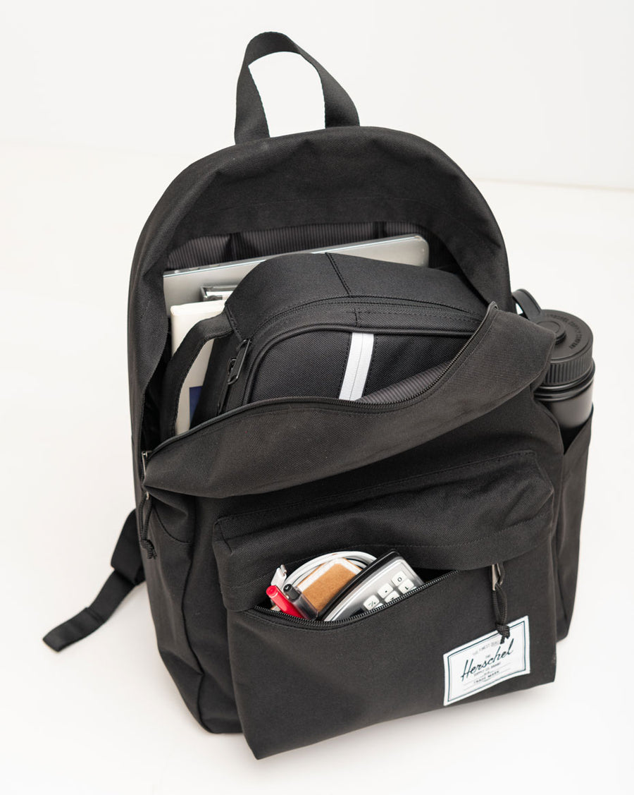Herschel Classic XL Backpack in Black Crosshatch, showing a spacious 30L design with dual water bottle pockets and a front storage sleeve.
