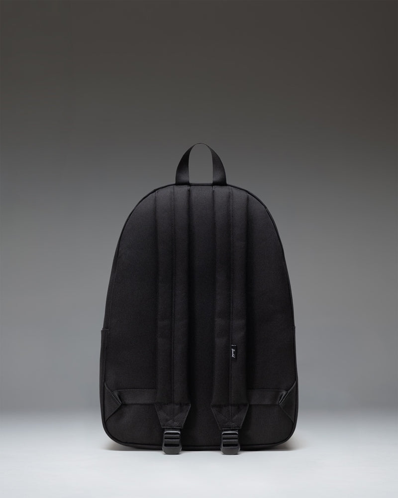 Herschel Classic XL Backpack in solid black, showing a clean front view with zippered pockets and a classic silhouette.