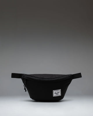 Black Herschel Classic Hip Pack featuring a main zippered compartment, front pocket, and adjustable webbed strap.