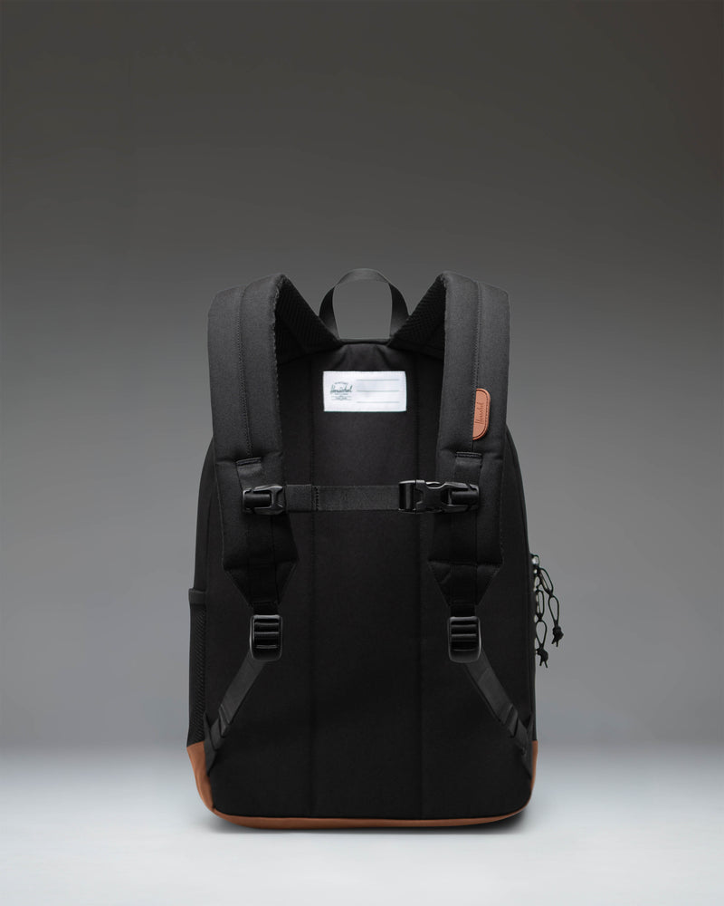 Herschel Heritage Youth Backpack in Black with a Saddle Brown diamond accent and base.