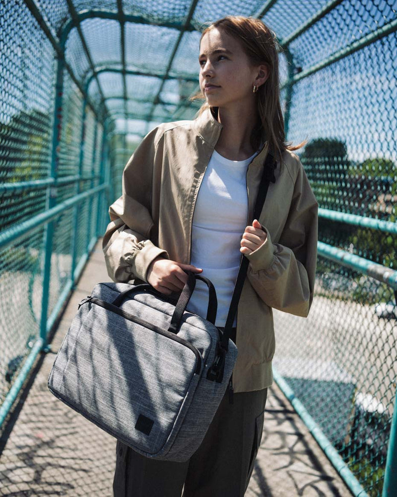Herschel Supply Co. Gibson Messenger Tech bag shown from a flat lay perspective, highlighting its multiple open compartments and pockets.