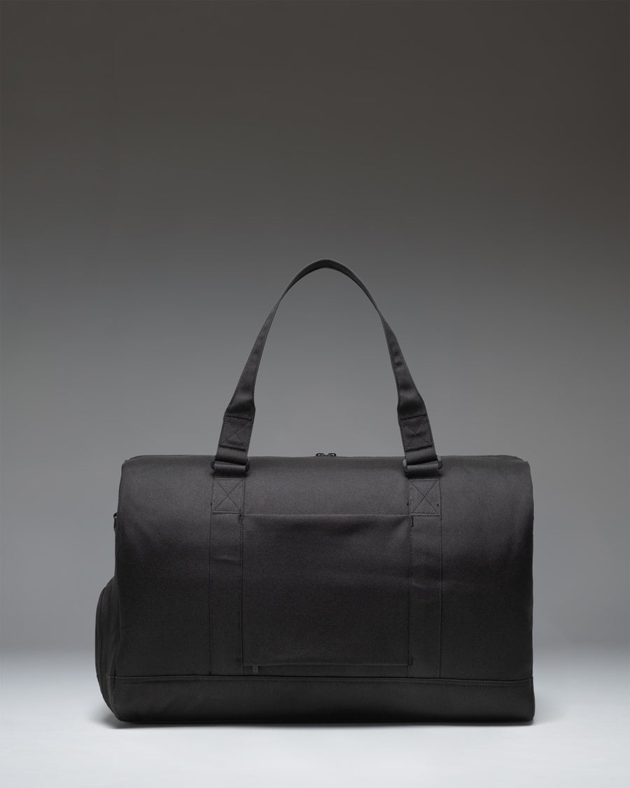 Black Herschel Novel Duffle Tech bag showcasing its sleek design, sturdy handles, and signature shoe compartment.