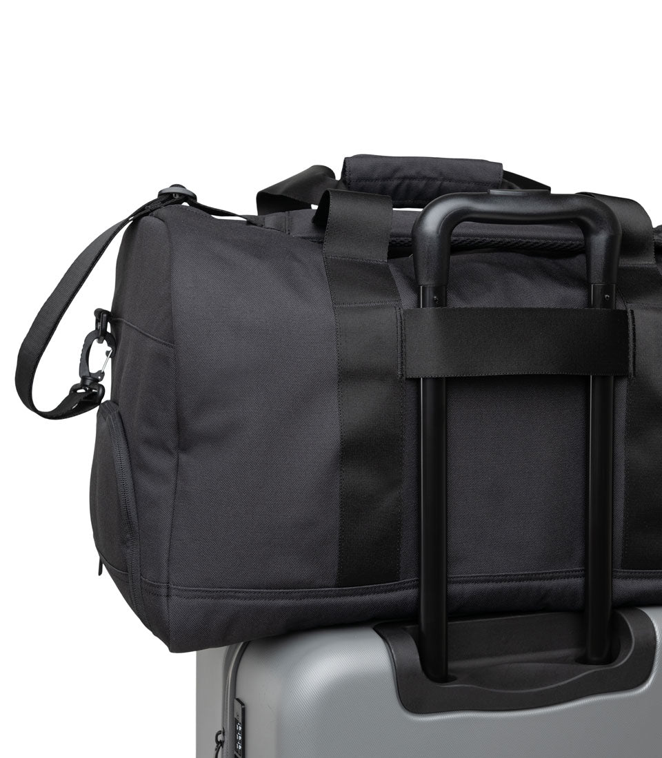 Herschel Novel Duffle Tech bag features highlighted: a dedicated tech compartment with a fleece-lined laptop sleeve and internal storage organizers.