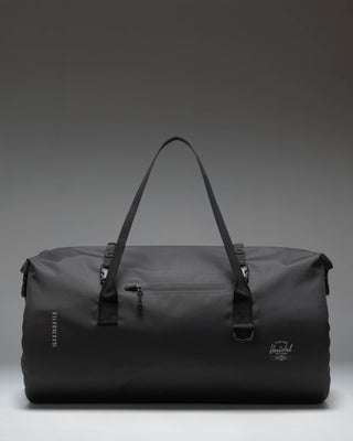 Herschel Supply Co. Dry Bag Duffle 55L in black, showcasing its durable waterproof material and roll-top closure design.