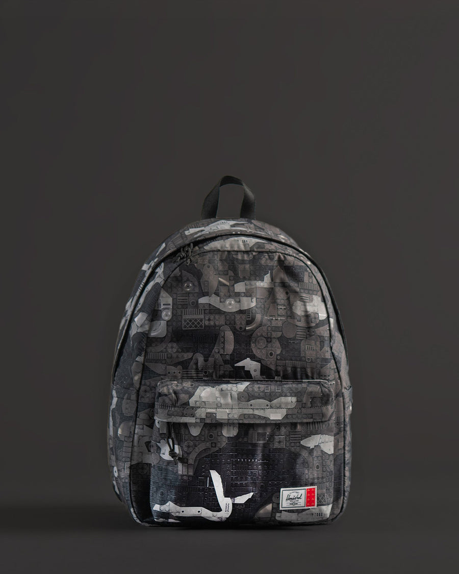Herschel Supply Co. LEGO Classic XL Backpack in Abstract Bricks Black featuring a black exterior with subtle, tonal LEGO brick patterns.