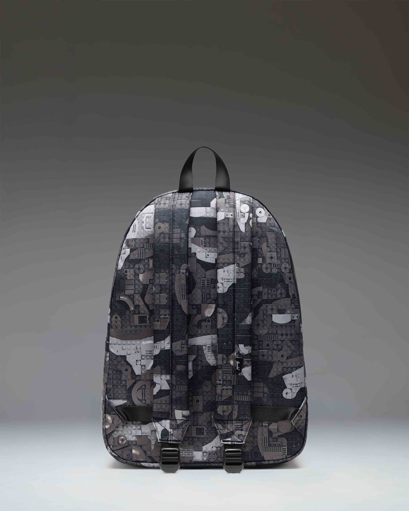 Herschel Classic XL Backpack in Abstract Bricks Black, featuring a colorful LEGO brick pattern on a black background.