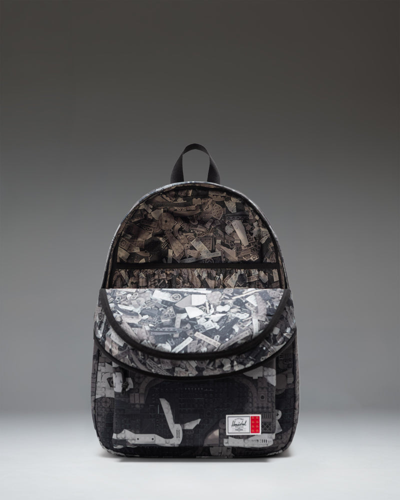 LEGO Herschel Classic XL Backpack in Abstract Bricks Black featuring an all-over black and white Lego brick pattern with a front storage pocket.