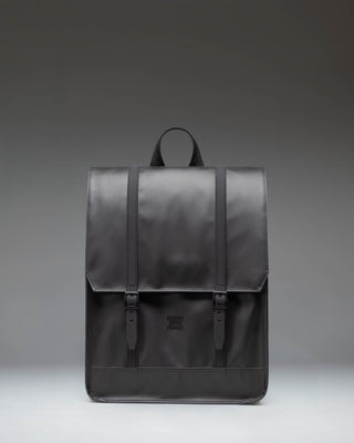 Herschel Survey Backpack in black, showing the front view with its classic square silhouette and dual strap closures.