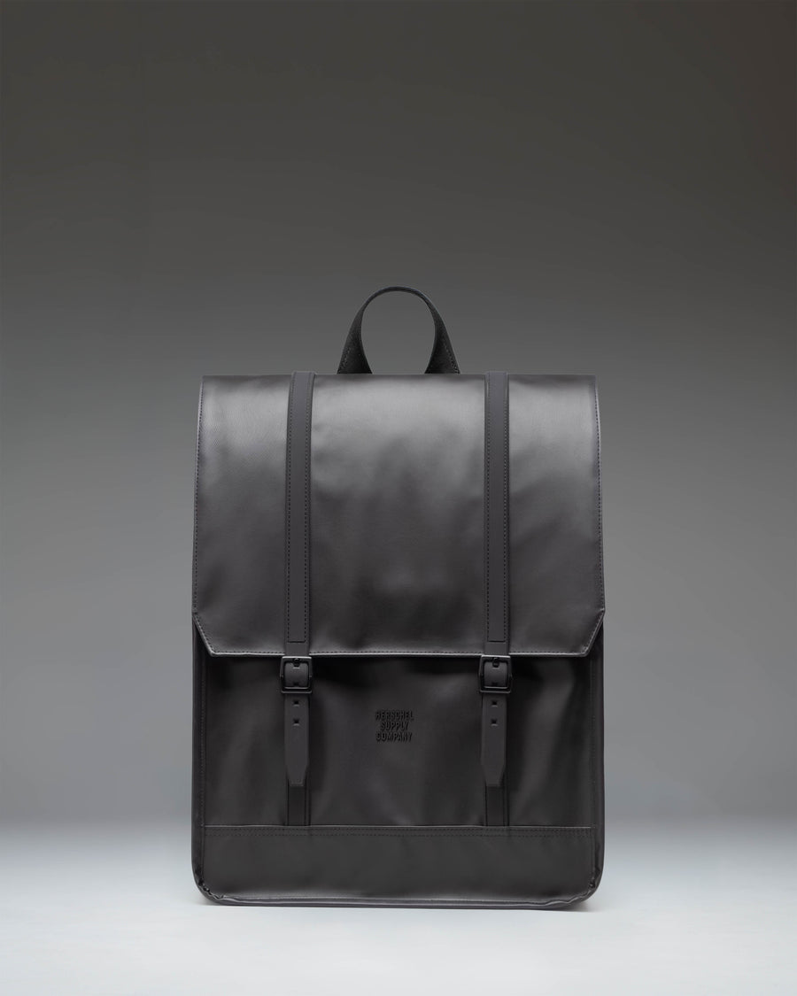 Herschel Survey Backpack in black, showing the front view with its classic square silhouette and dual strap closures.