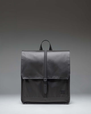 Herschel Supply Co City Backpack in black, showcasing a minimalist design with a single strap closure and a clean, modern aesthetic.