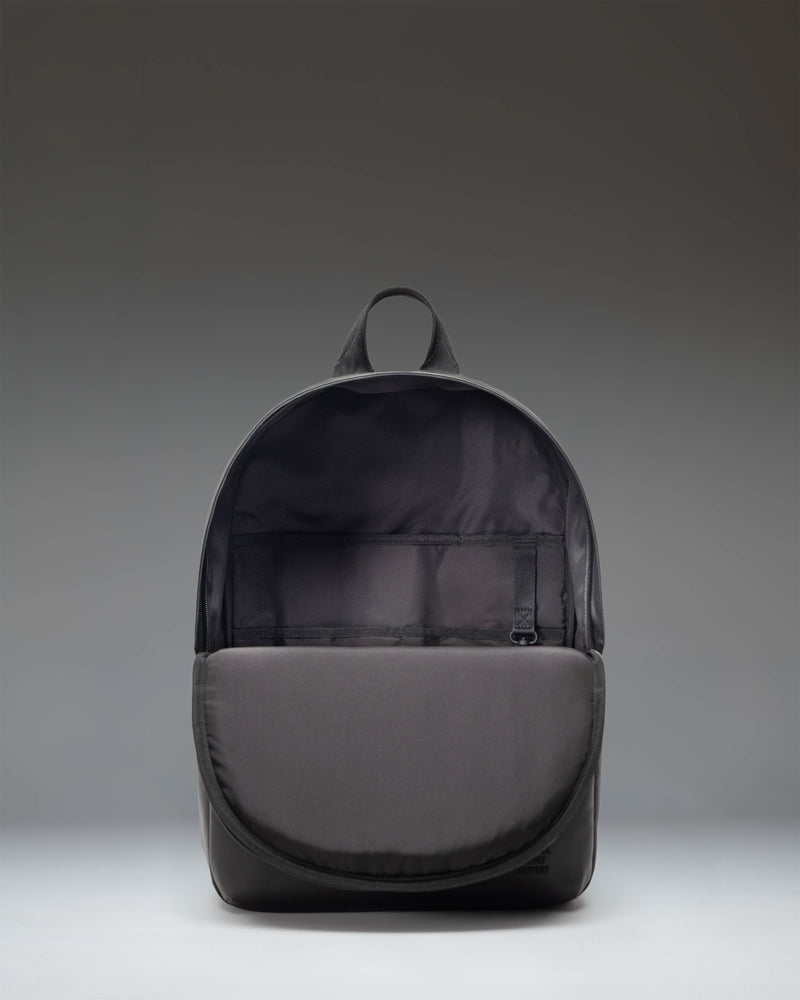 Herschel Supply Co. Alberni Backpack in solid black, showcasing its clean design, modern structure, and durable fabric for everyday travel.