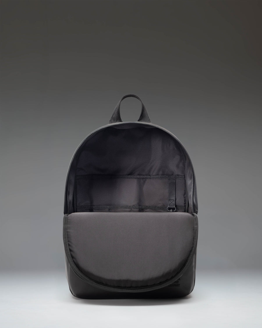Herschel Supply Co. Alberni Backpack in solid black, showcasing its clean design, modern structure, and durable fabric for everyday travel.