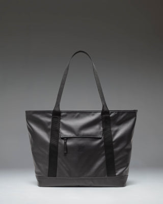 Herschel Supply Co. Alberni Tote in black, shown from a front perspective, highlighting its clean, durable design.