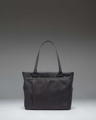 Black Herschel Supply Co. Kaslo Tote Tech bag shown from a front perspective, highlighting its clean, functional design.