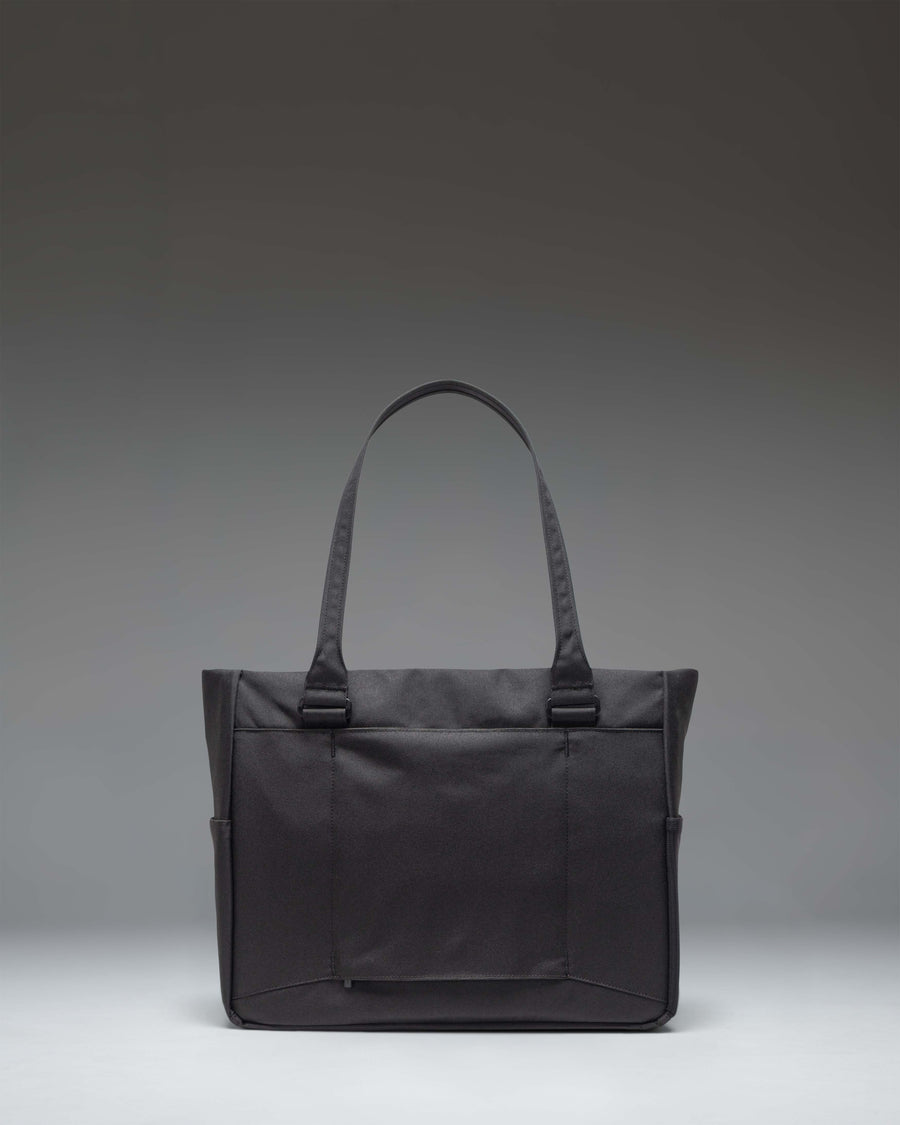 Herschel Supply Co. Kaslo Tote Tech bag in black, showcasing its sleek design and durable material, perfect for daily commutes and travel.