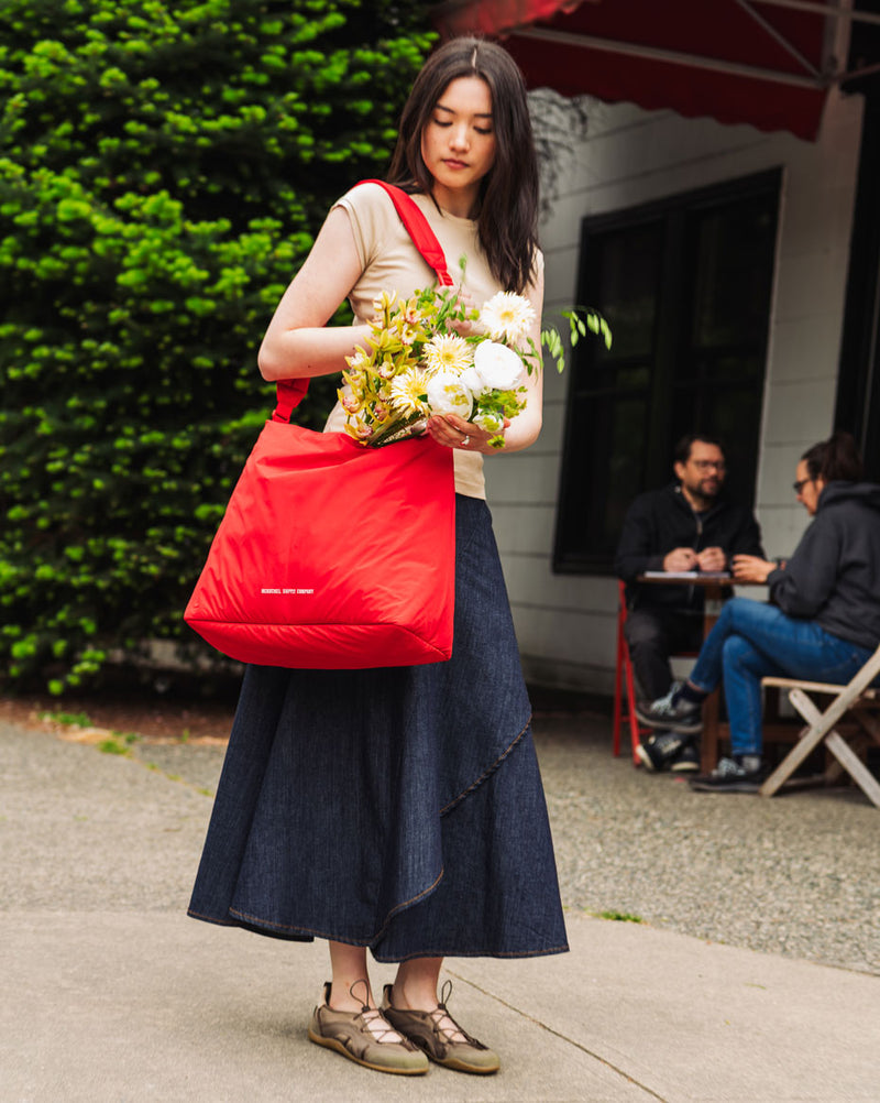 Herschel Supply Co. Cloudform Tote in black, showcasing its minimalist, padded design and lightweight fabric.