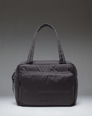Herschel Supply Co. Cloudform Duffle bag in black, showing the clean, minimalist exterior design and durable carrying straps.