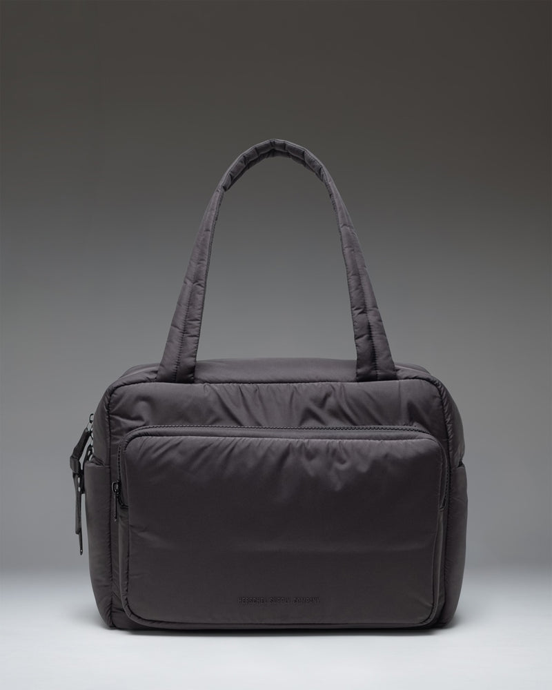 Herschel Supply Co. Cloudform Duffle bag in black, showing the clean, minimalist exterior design and durable carrying straps.
