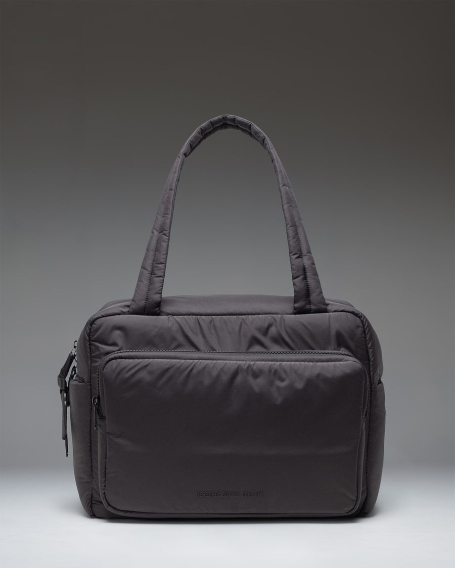 Herschel Supply Co. Cloudform Duffle bag in black, showing the clean, minimalist exterior design and durable carrying straps.