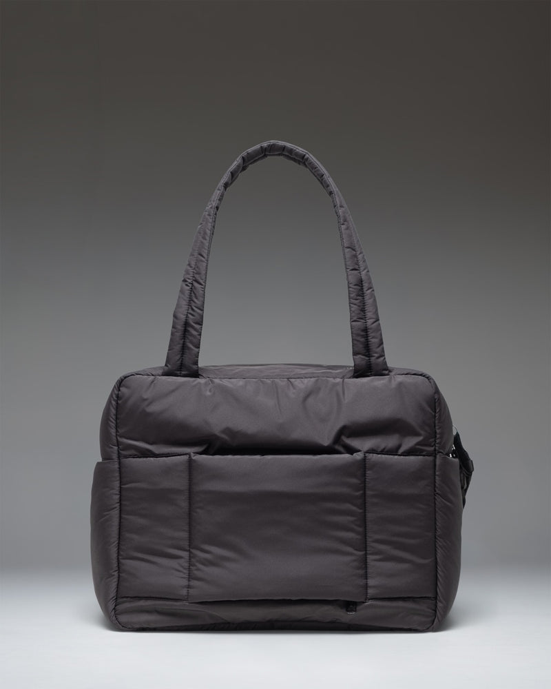 Herschel Supply Co. Cloudform Duffle bag in sleek all-black, showcasing its durable fabric, minimalist design, and sturdy carrying handles.