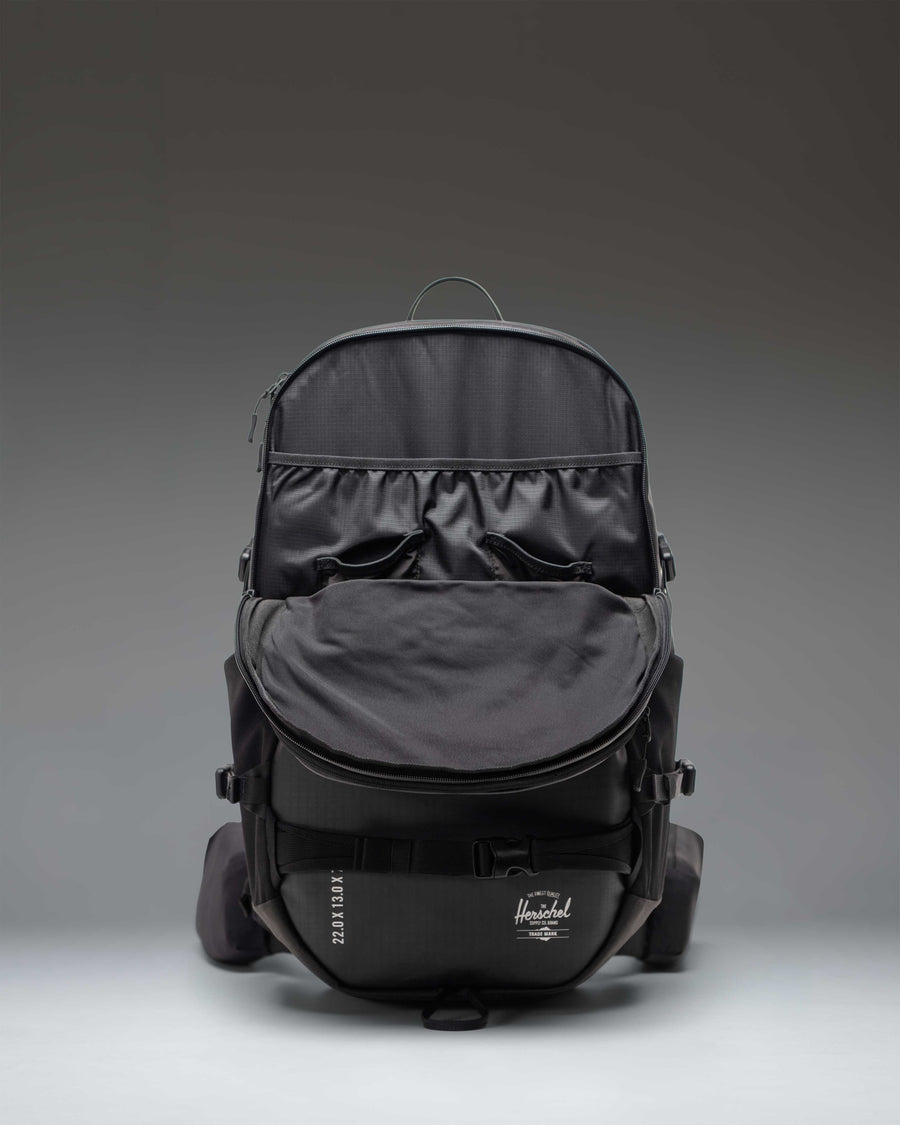 Herschel Supply Co. All Season Pro Backpack 36L in black, showcasing its technical design and multi-purpose utility straps.