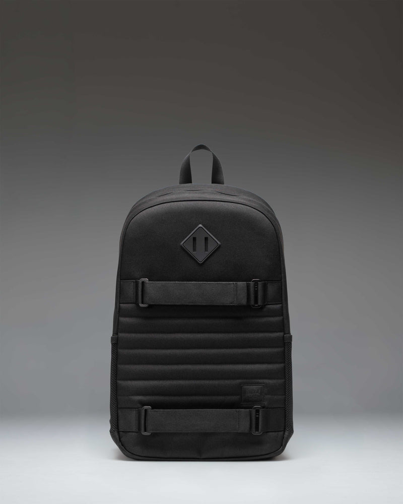 Herschel Supply Co. Fleet Skate Backpack in black, featuring an open front pocket with adjustable skate straps and a classic woven label.