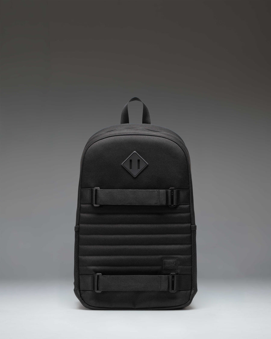 Herschel Supply Co. Fleet Skate Backpack in black, featuring an open front pocket with adjustable skate straps and a classic woven label.