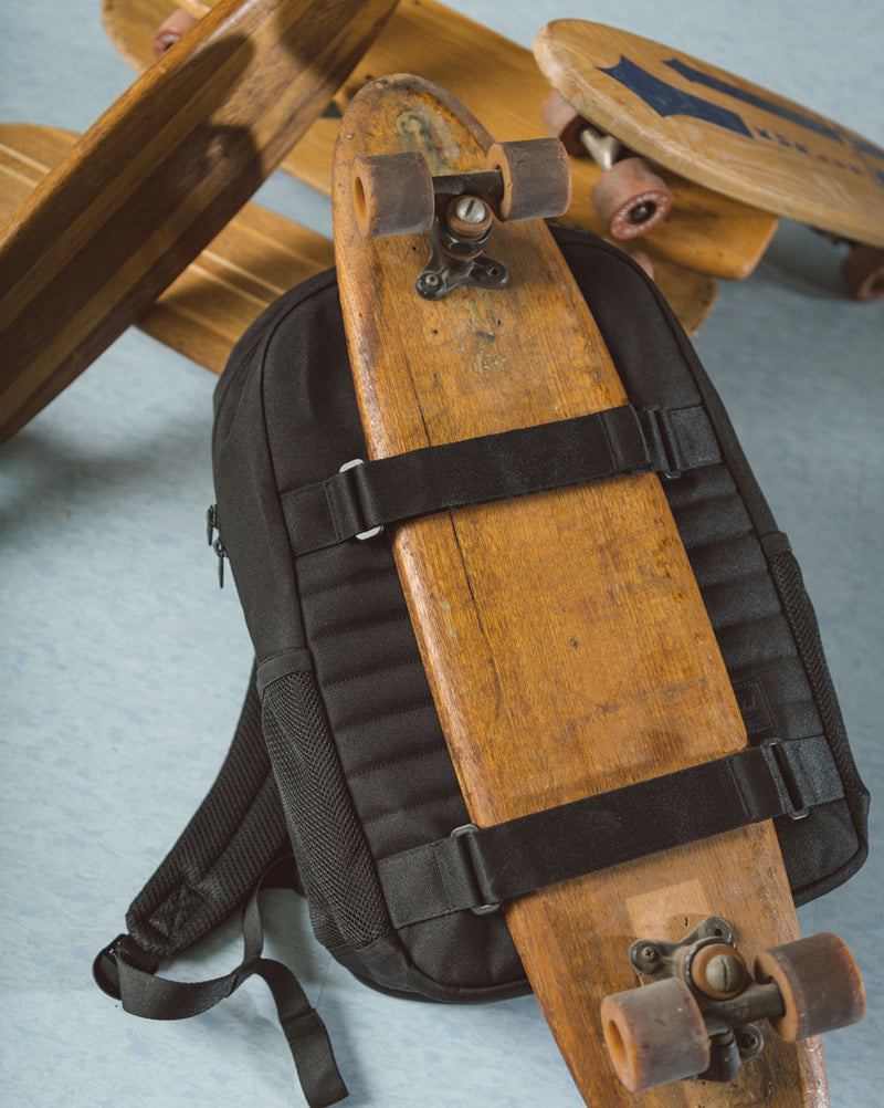 Herschel Fleet Skate Backpack in black, showcasing a multi-purpose design with signature diamond detail and self-fastening straps.