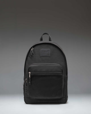 Herschel Supply Co. Kaine Backpack in black, featuring a front storage pocket, side water bottle pockets, and adjustable shoulder straps.