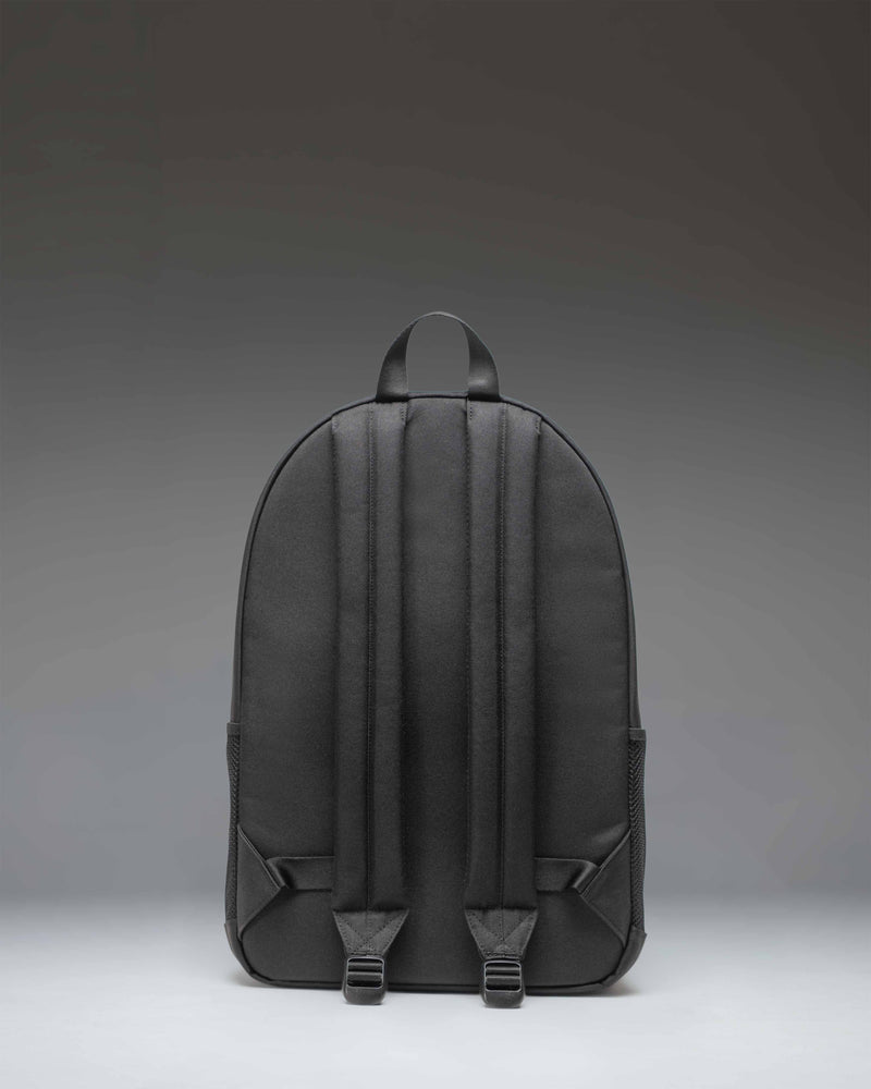 Herschel Supply Co. Kaine Backpack in solid black, featuring utility straps, mesh side pockets, and a classic woven label.