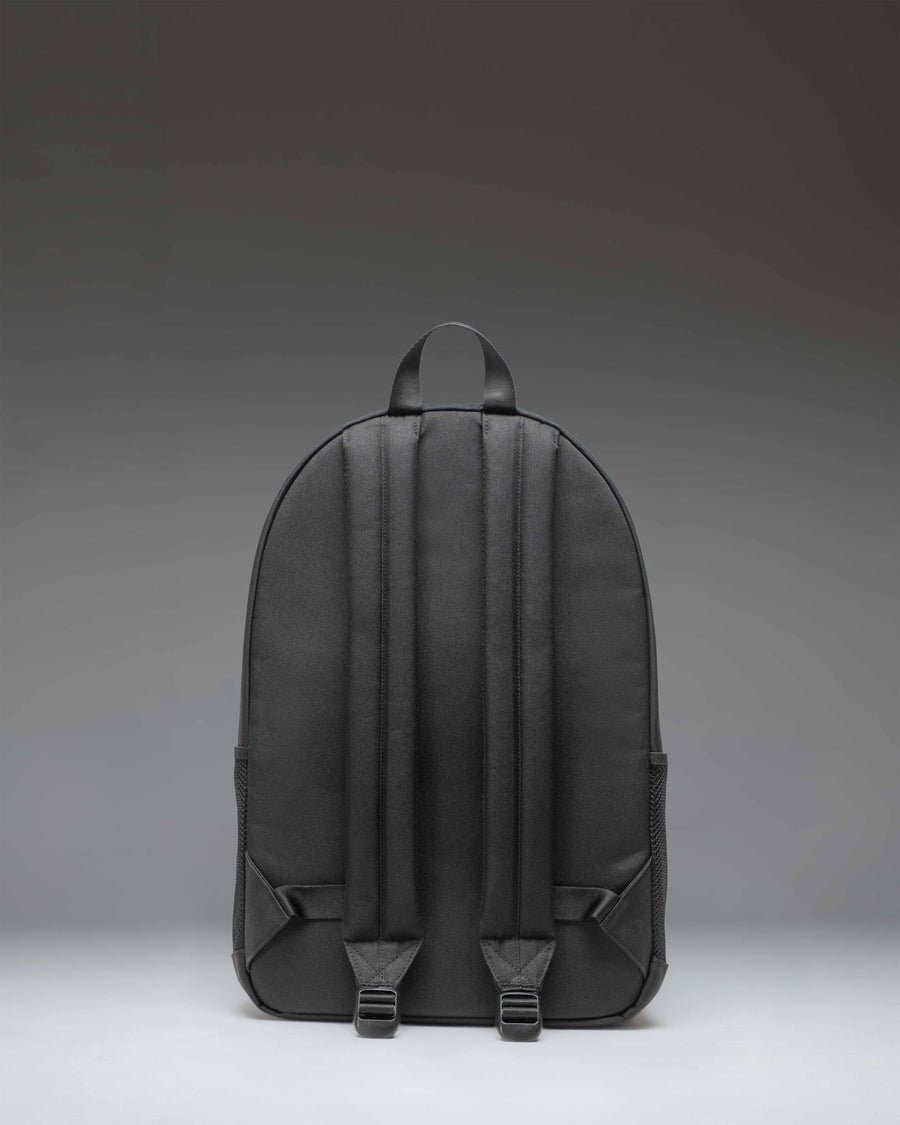 Herschel Supply Co. Kaine Backpack in solid black, featuring utility straps, mesh side pockets, and a classic woven label.